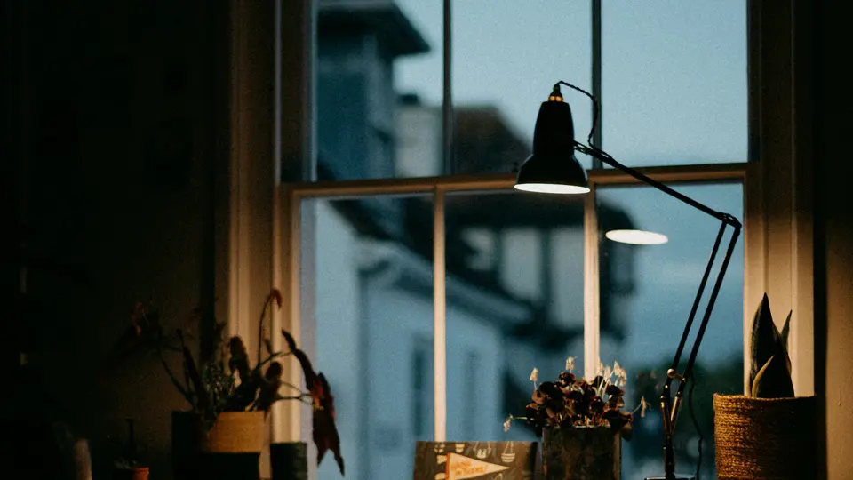 A wide crop of a real desk-lamp photograph, also used for the video poster.